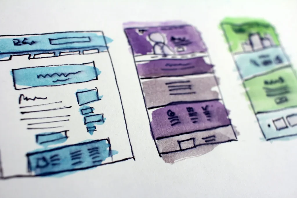 Hand-painted wireframe sketches of website page layouts
